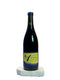 Wine bottle with a blue and yellow label on a white surface