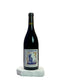 Wine bottle labeled 'Le Grain du Vin' on a white surface with a light gray background