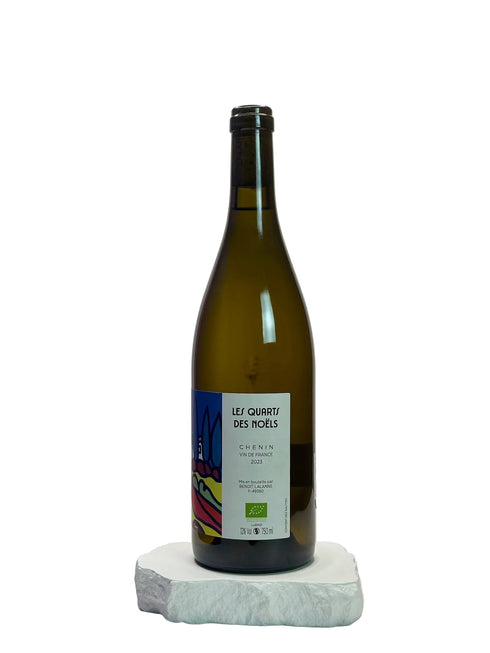 Wine bottle with a label on a white surface and light gray background