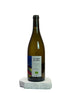 Wine bottle with a label on a white surface and light gray background