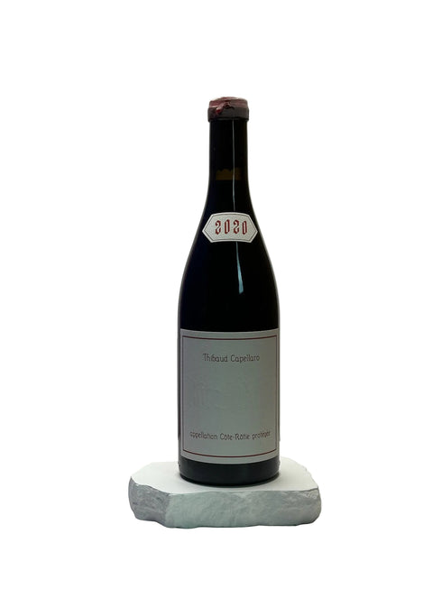 Bottle of wine with a label on a white surface