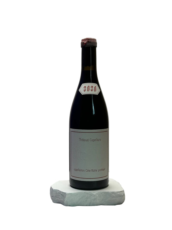Bottle of wine with a label on a white surface