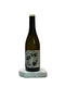 Dark green bottle with a label on a white surface
