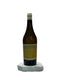 Wine bottle labeled 'Cotes du Jura' on a white surface with a neutral background