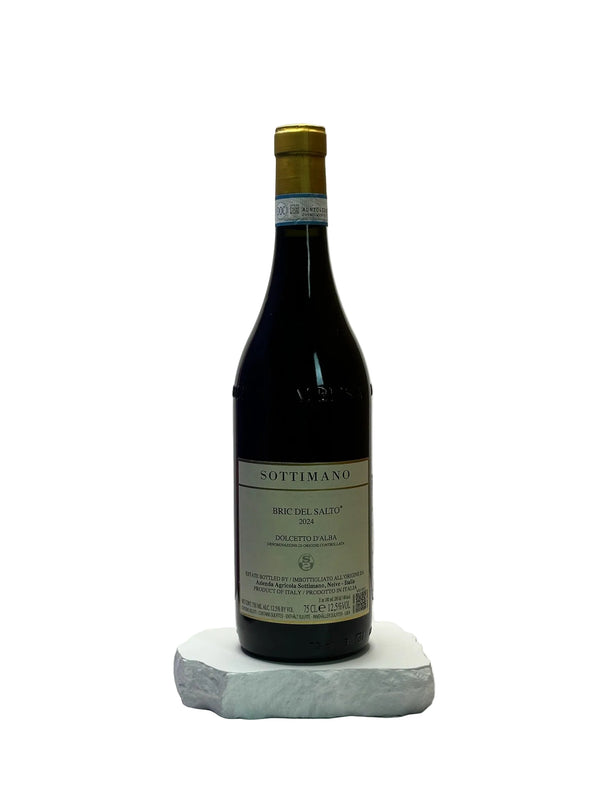 Bottle of Sottimano wine on a white surface with a neutral background
