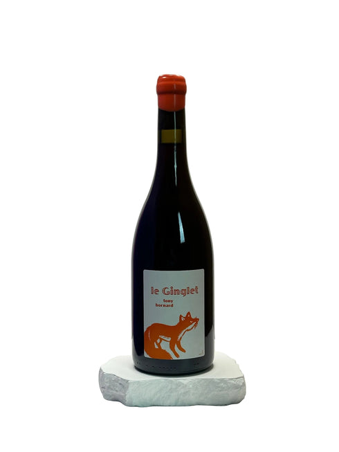 Wine bottle with a label featuring a fox on a white surface