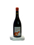 Wine bottle with a label featuring a fox on a white surface
